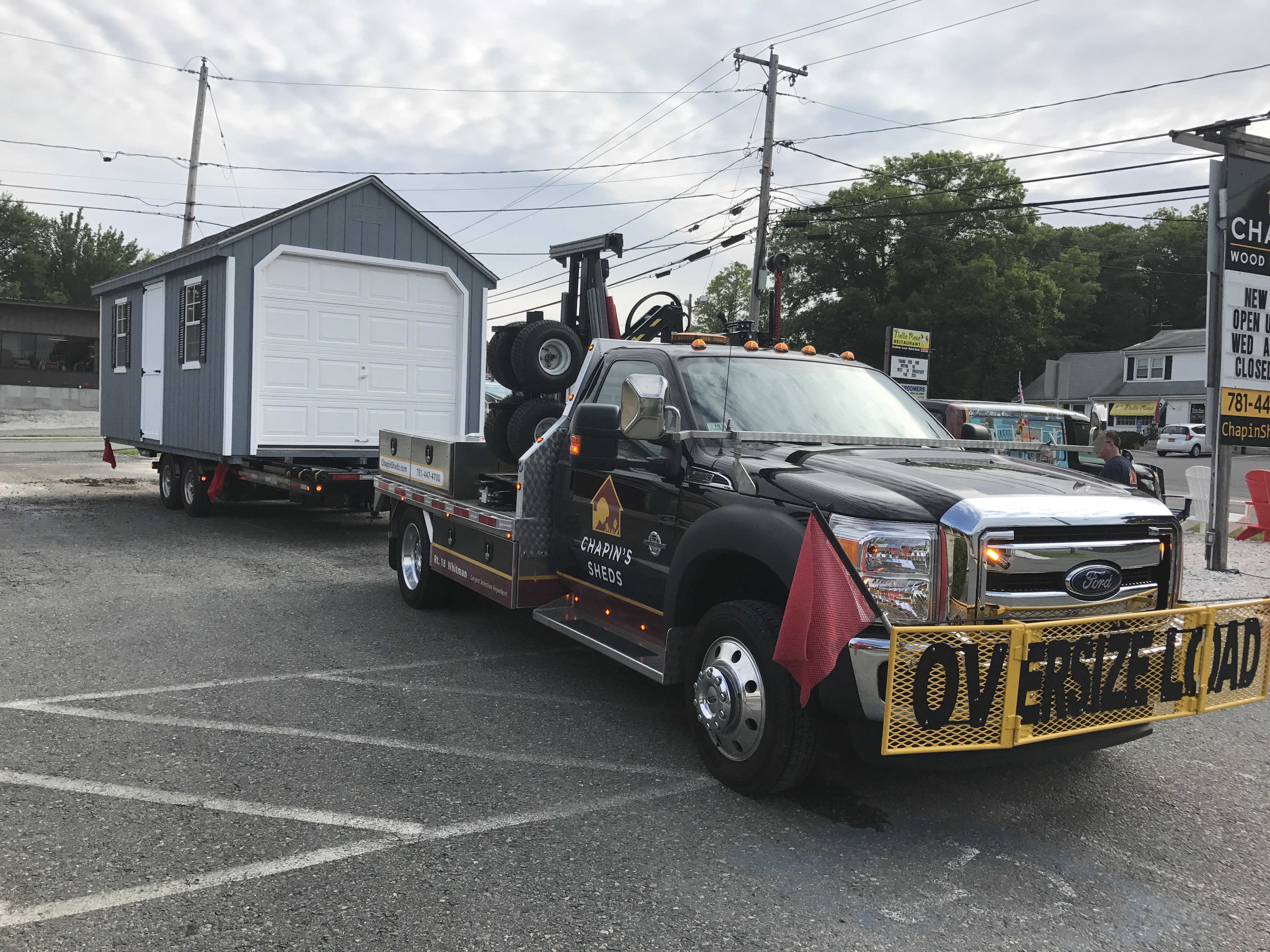 Close-Up of a Truck Pulling a Pre-Built Shed
